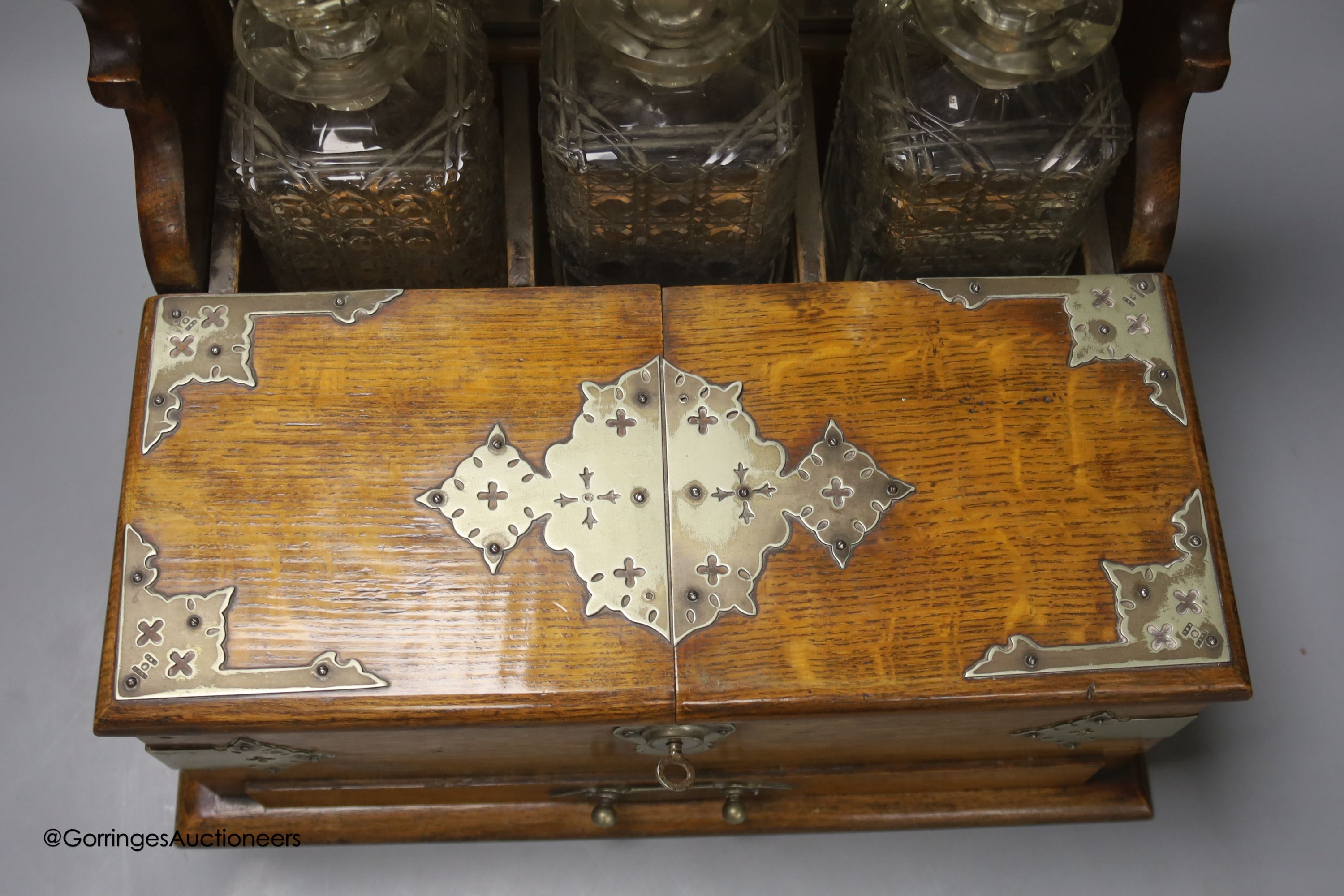 A Victorian oak tantalus and games compendium, height 33cm depth 29cm width 38cm
